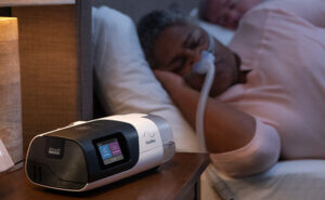 ResMed-sleep-apnoea-patient-sleeping-nasal-mask-CPAP-device_mobile