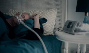 resmed-sleep-apnoea-patient-sleeping-CPAP-mask-device
